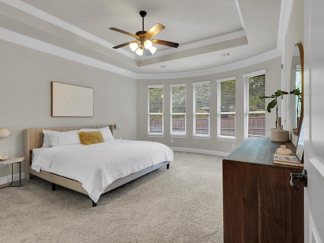 bedroom with visible vents, a raised ceiling, baseboards, ornamental molding, and light carpet