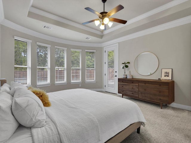 carpeted bedroom with crown molding, access to exterior, a tray ceiling, and visible vents