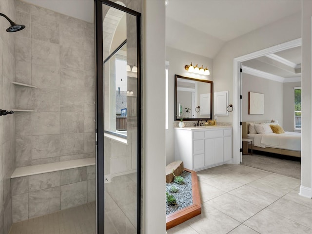 bathroom with connected bathroom, tile patterned flooring, vanity, a shower stall, and ornamental molding
