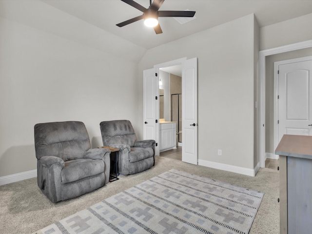 sitting room featuring a ceiling fan, baseboards, vaulted ceiling, and light carpet
