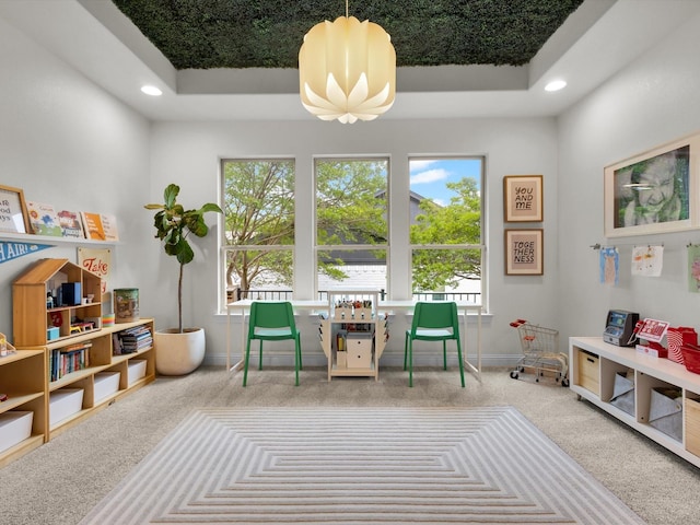 interior space with carpet floors, baseboards, a tray ceiling, and recessed lighting