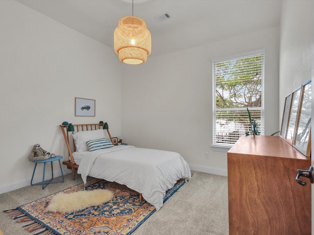 bedroom with baseboards, carpet flooring, visible vents, and multiple windows