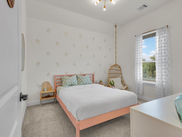 bedroom featuring baseboards, visible vents, and light colored carpet