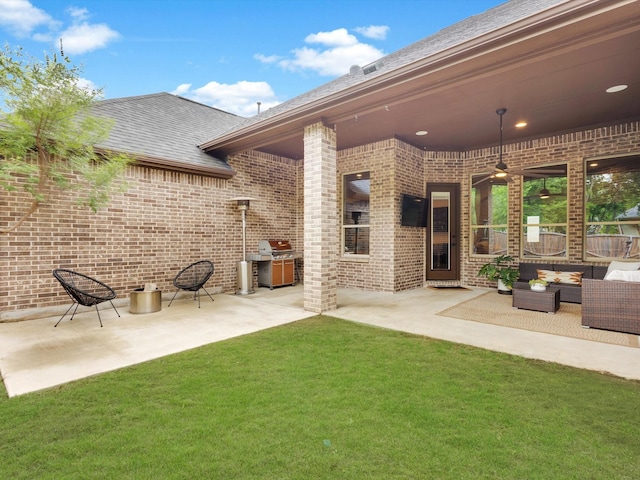 back of house with brick siding, ceiling fan, an outdoor hangout area, and a patio area