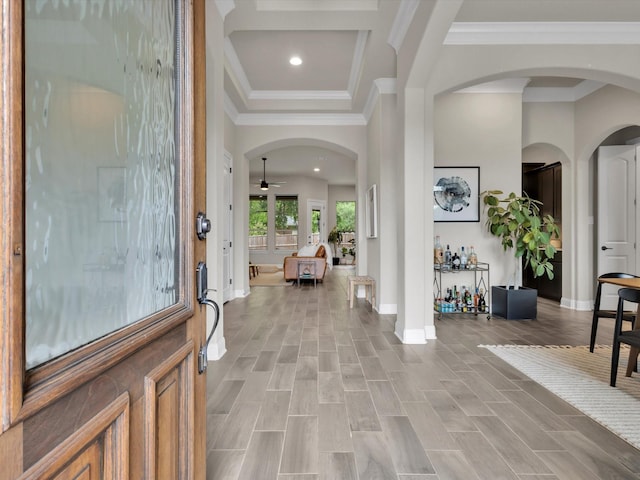 entryway with a ceiling fan, arched walkways, baseboards, ornamental molding, and recessed lighting