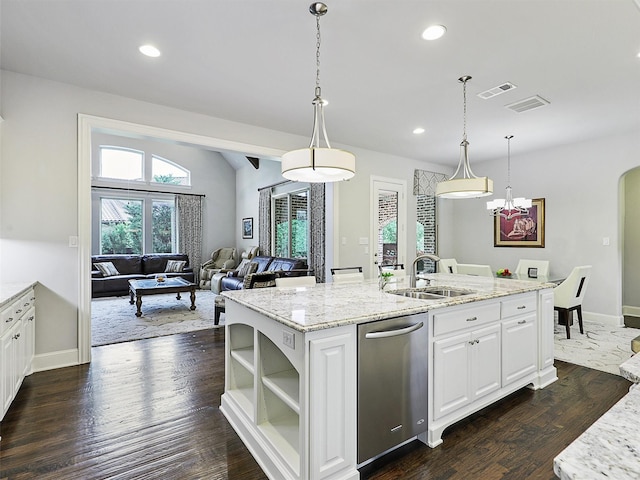 kitchen with stainless steel dishwasher, visible vents, a sink, and a kitchen island with sink