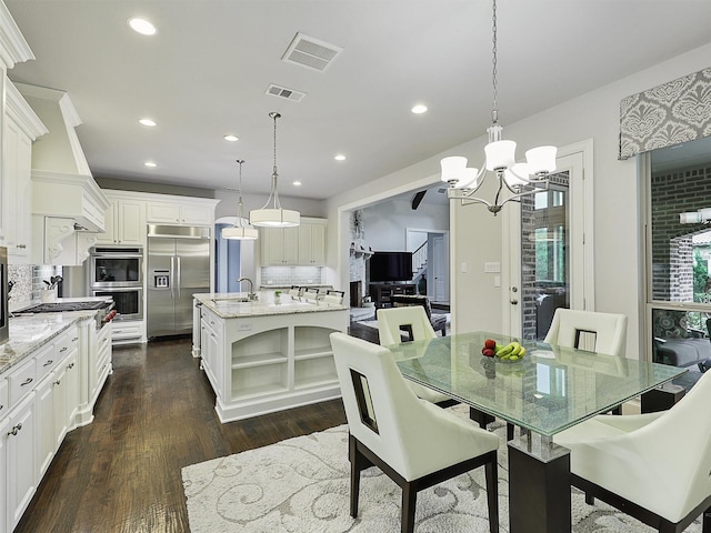 dining space featuring an inviting chandelier, dark wood-type flooring, recessed lighting, and visible vents