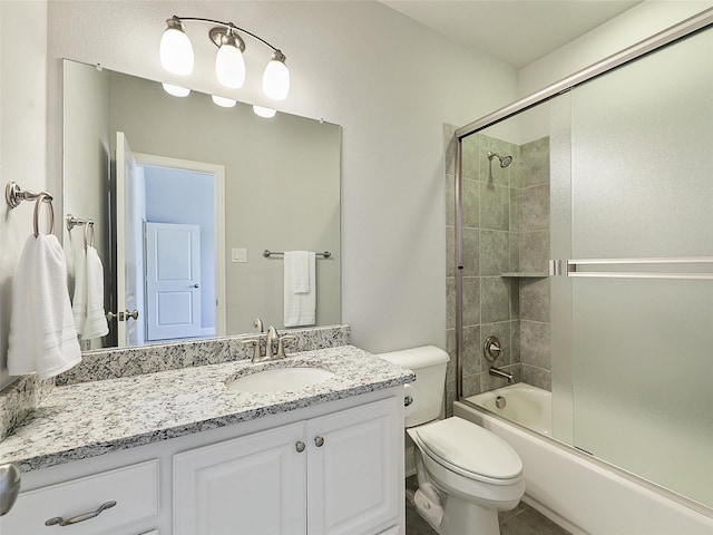 12643 Canyon Oaks Dr, Frisco, TX 75033 - bathroom featuring vanity, toilet, and bath / shower combo with glass door