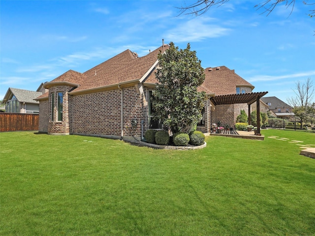 rear view of house with a patio area, brick siding, fence, a yard, and a pergola