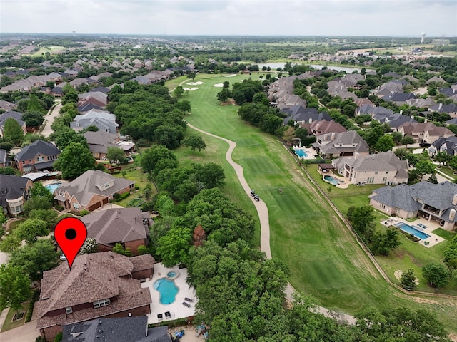 drone / aerial view featuring golf course view and a residential view