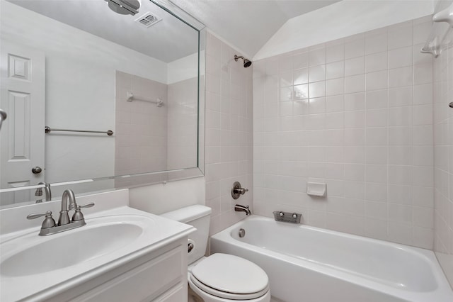 bathroom featuring visible vents, vanity, toilet, lofted ceiling, and bathing tub / shower combination