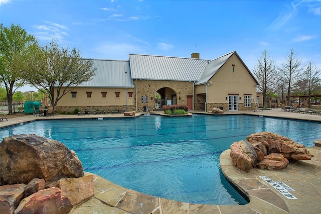 community pool with a patio area