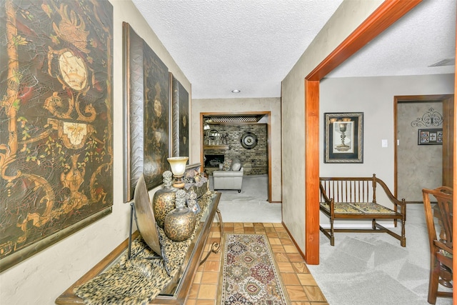 hall with a textured ceiling