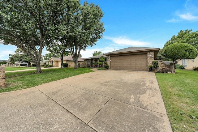 ranch-style home featuring a garage, driveway, and a front lawn