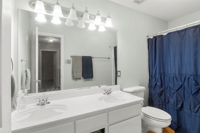 bathroom featuring double vanity, toilet, a shower with shower curtain, and a sink