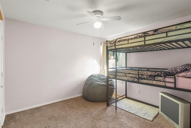 carpeted bedroom with baseboards and ceiling fan