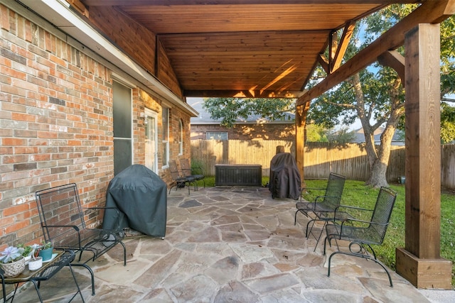 view of patio with a fenced backyard and a grill