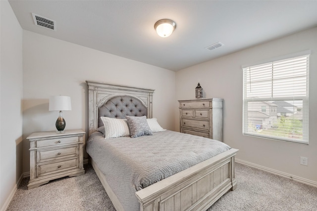 bedroom with visible vents, baseboards, and light colored carpet