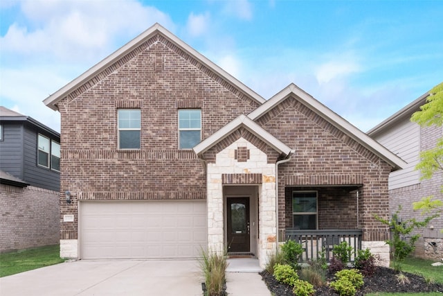 view of front facade with an attached garage, driveway, stone siding, and brick siding
