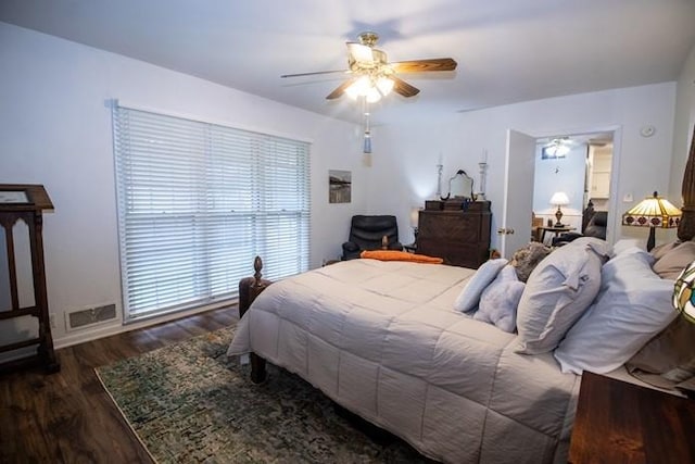 bedroom with a ceiling fan, wood finished floors, and visible vents
