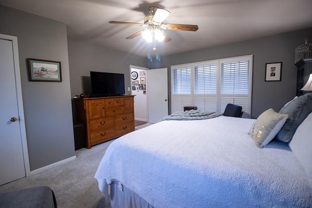 bedroom featuring baseboards, ceiling fan, and light colored carpet
