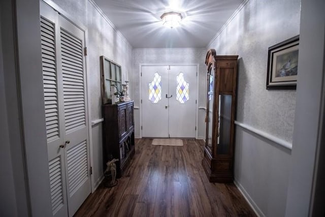 doorway to outside featuring crown molding and dark wood-style floors