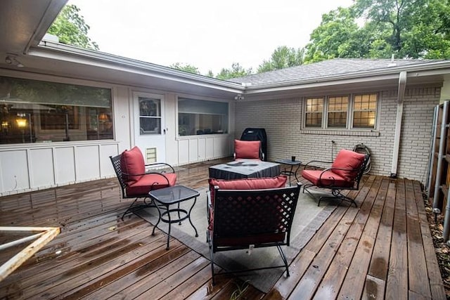 wooden deck with an outdoor living space