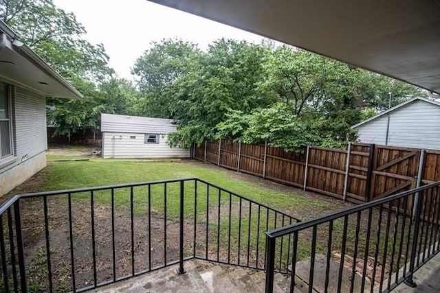 view of yard with a fenced backyard and an outbuilding