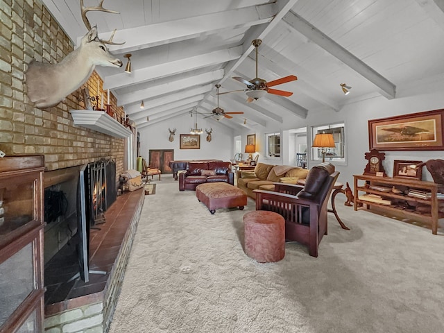 living area with vaulted ceiling with beams, a ceiling fan, a brick fireplace, and carpet floors