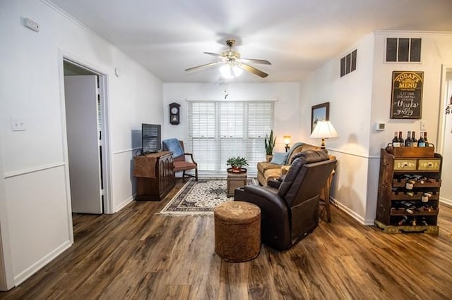 living area featuring baseboards, a ceiling fan, dark wood-style flooring, and visible vents