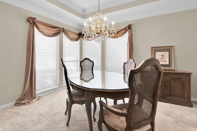 dining area featuring crown molding, a notable chandelier, light carpet, a raised ceiling, and baseboards