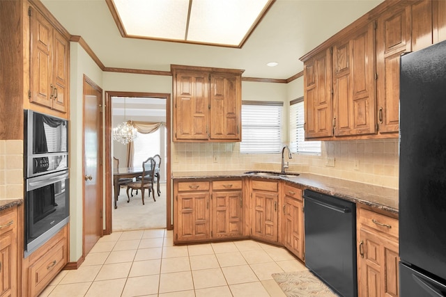 kitchen featuring a sink, crown molding, backsplash, and black appliances