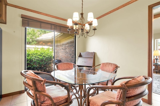 dining room featuring light tile patterned floors, baseboards, ornamental molding, and a chandelier