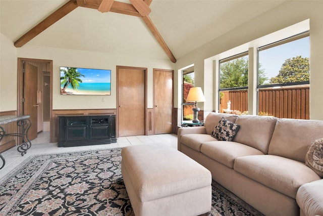 living area with beamed ceiling, light tile patterned floors, and high vaulted ceiling