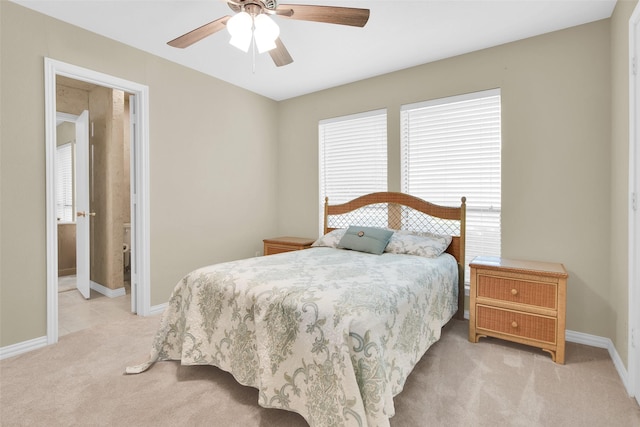 bedroom with light colored carpet, a ceiling fan, and baseboards