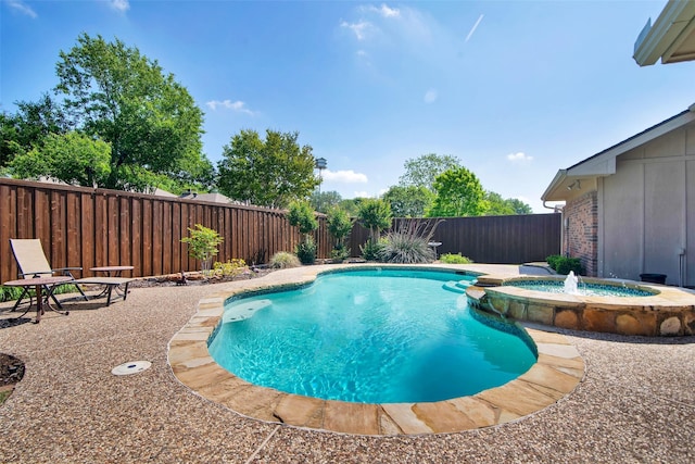 view of pool featuring a fenced backyard and a pool with connected hot tub