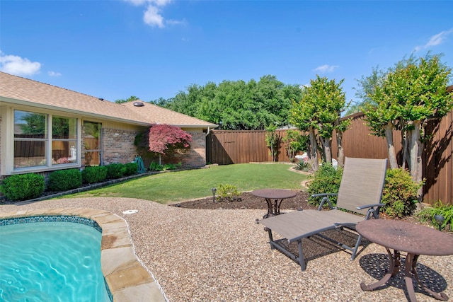 view of yard featuring a patio, a fenced in pool, and a fenced backyard