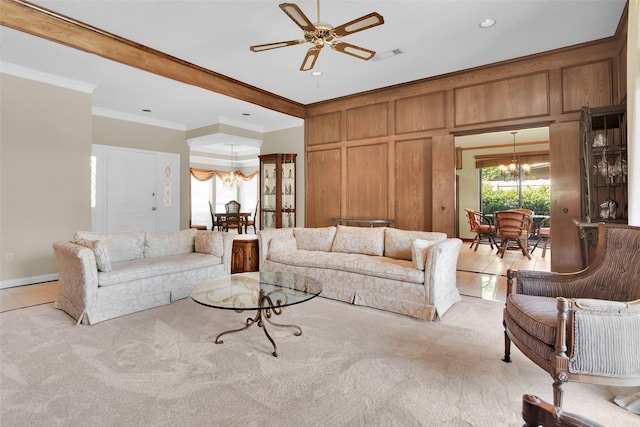 living area with light colored carpet, ceiling fan with notable chandelier, recessed lighting, light tile patterned floors, and ornamental molding