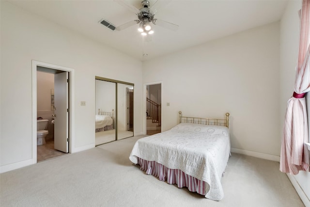 carpeted bedroom with ceiling fan, visible vents, baseboards, a closet, and connected bathroom
