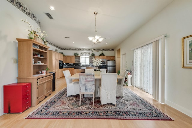 dining room with an inviting chandelier, light wood-style floors, recessed lighting, baseboards, and visible vents
