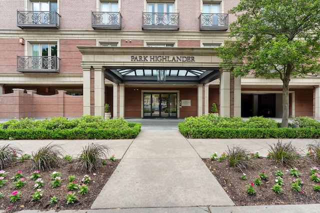 property entrance featuring brick siding