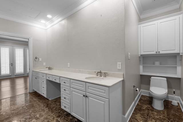 bathroom featuring baseboards, a sink, and ornamental molding