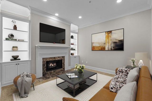 living area featuring crown molding, a premium fireplace, built in shelves, recessed lighting, and baseboards