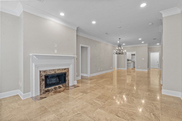 unfurnished living room with a chandelier, recessed lighting, baseboards, a high end fireplace, and ornamental molding