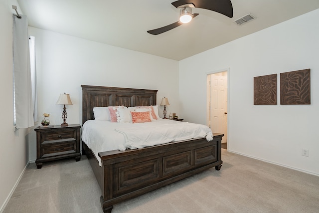 bedroom featuring baseboards, visible vents, light carpet, and ceiling fan