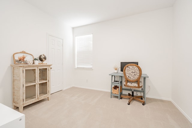sitting room with baseboards and carpet