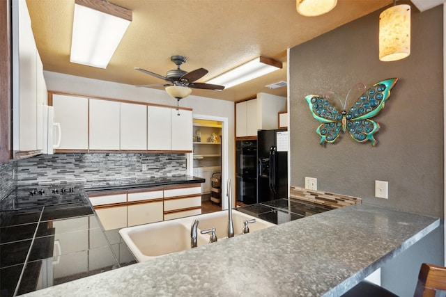kitchen with visible vents, dark countertops, a ceiling fan, backsplash, and black appliances