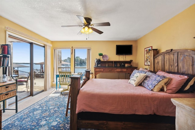 carpeted bedroom featuring access to outside and ceiling fan