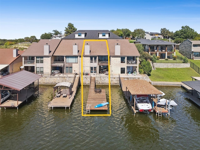 dock area featuring a residential view, fence, boat lift, and a water view
