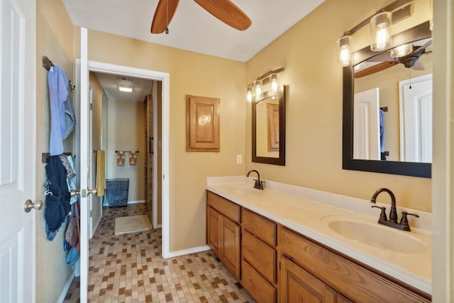 bathroom with a sink, a ceiling fan, and double vanity